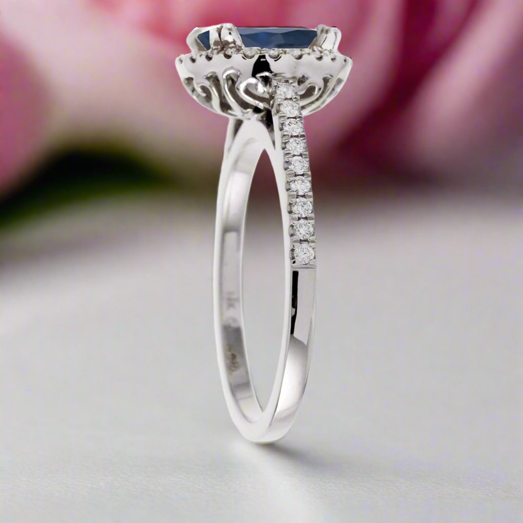 Round sapphire engagement ring with a diamond halo in white gold