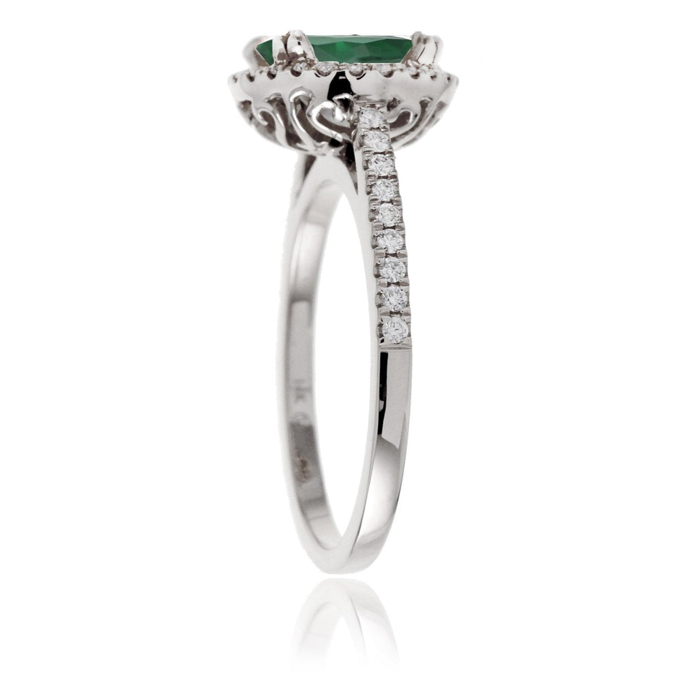 Round cut emerald ring with a diamond halo in white gold