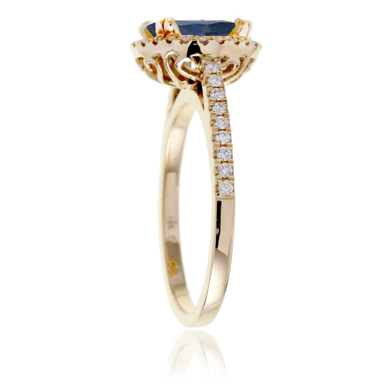 Round sapphire engagement ring with a diamond halo in yellow gold