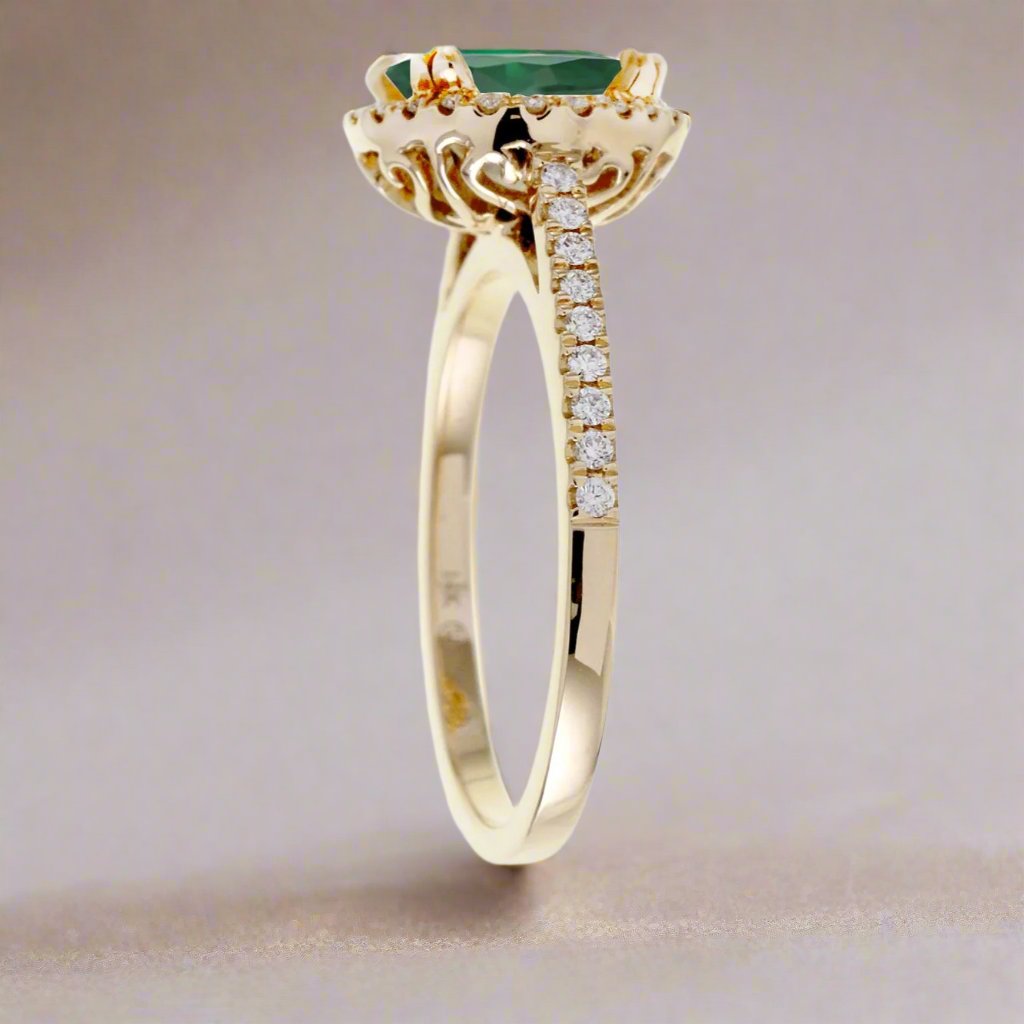 Round cut emerald ring with a diamond halo in yellow gold