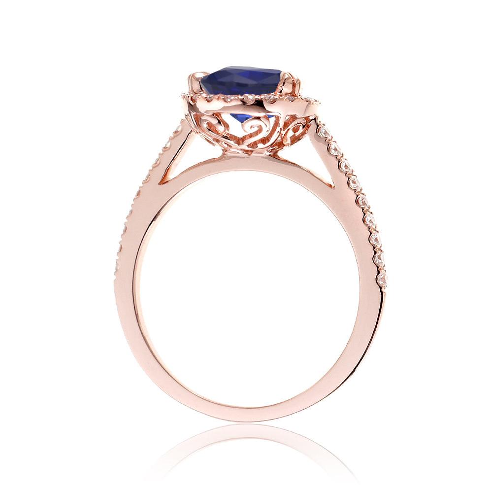 Round sapphire engagement ring with a diamond halo in rose gold