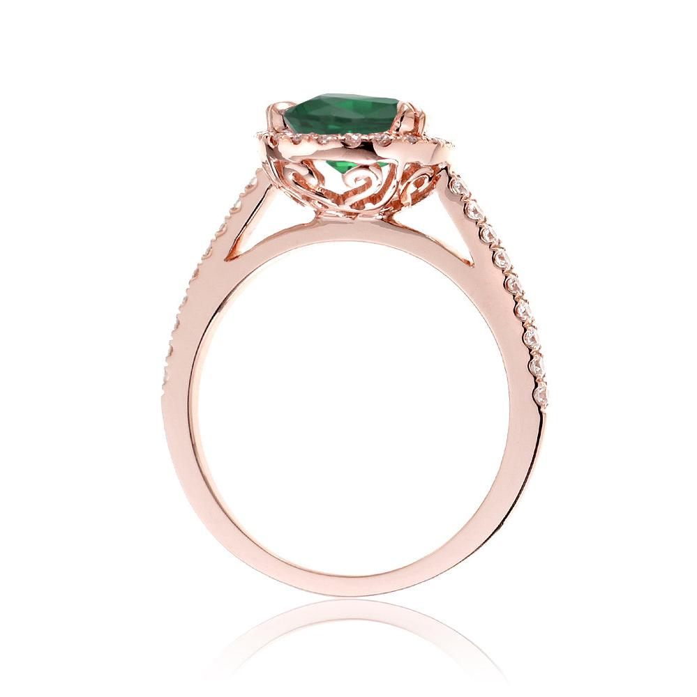 Round cut emerald ring with a diamond halo in rose gold