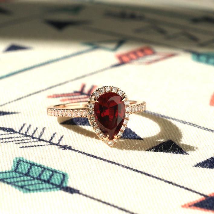 Pear ruby ring with diamond halo