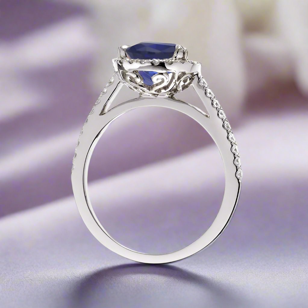 Round sapphire engagement ring with a diamond halo in white gold