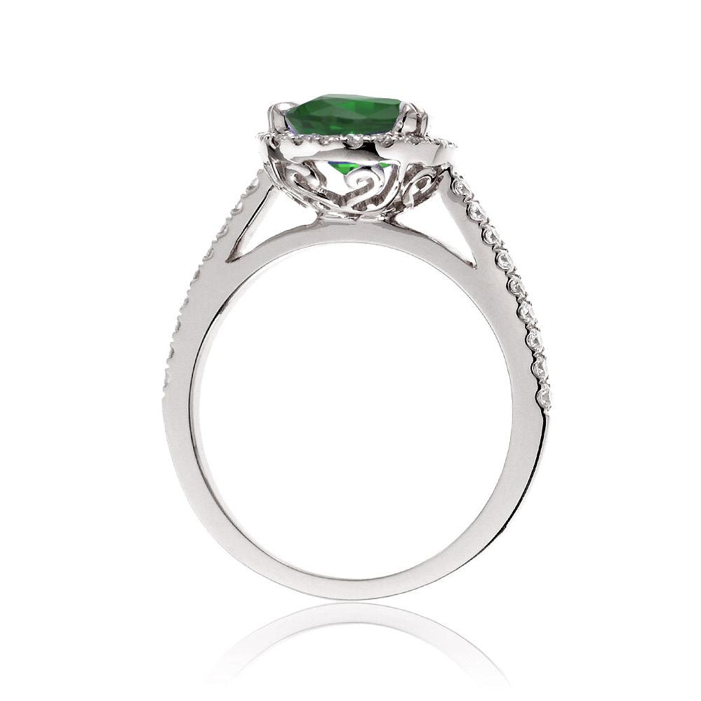 Round cut emerald ring with a diamond halo in white gold