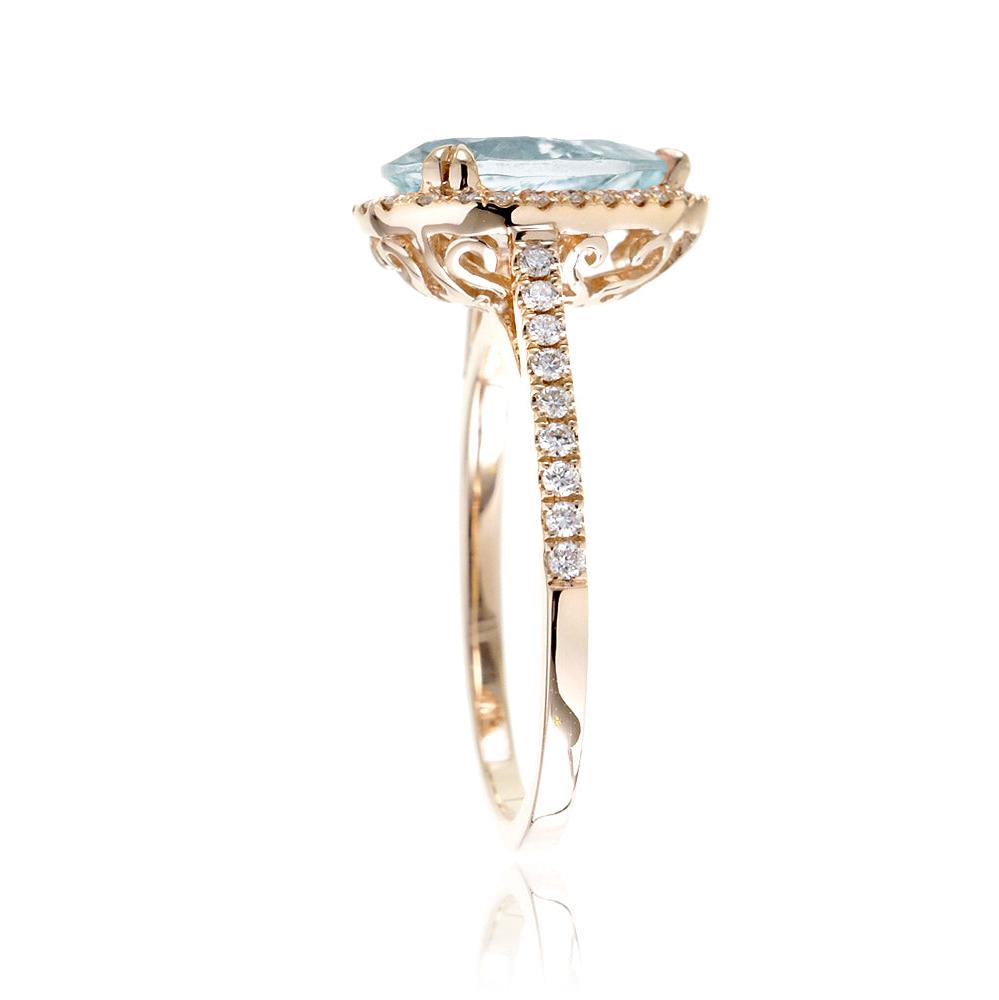 Pear aquamarine engagement ring with halo in yellow gold