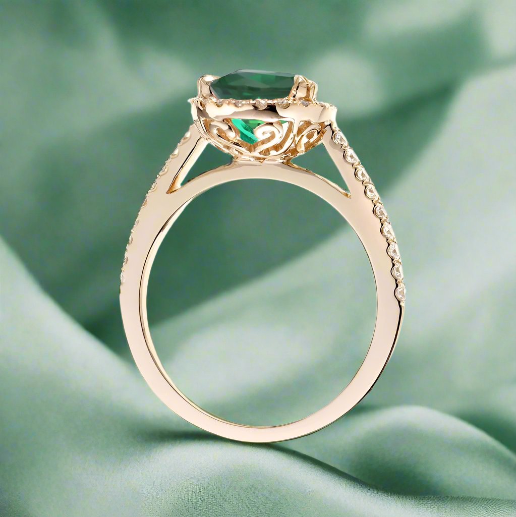 Round cut emerald ring with a diamond halo in yellow gold