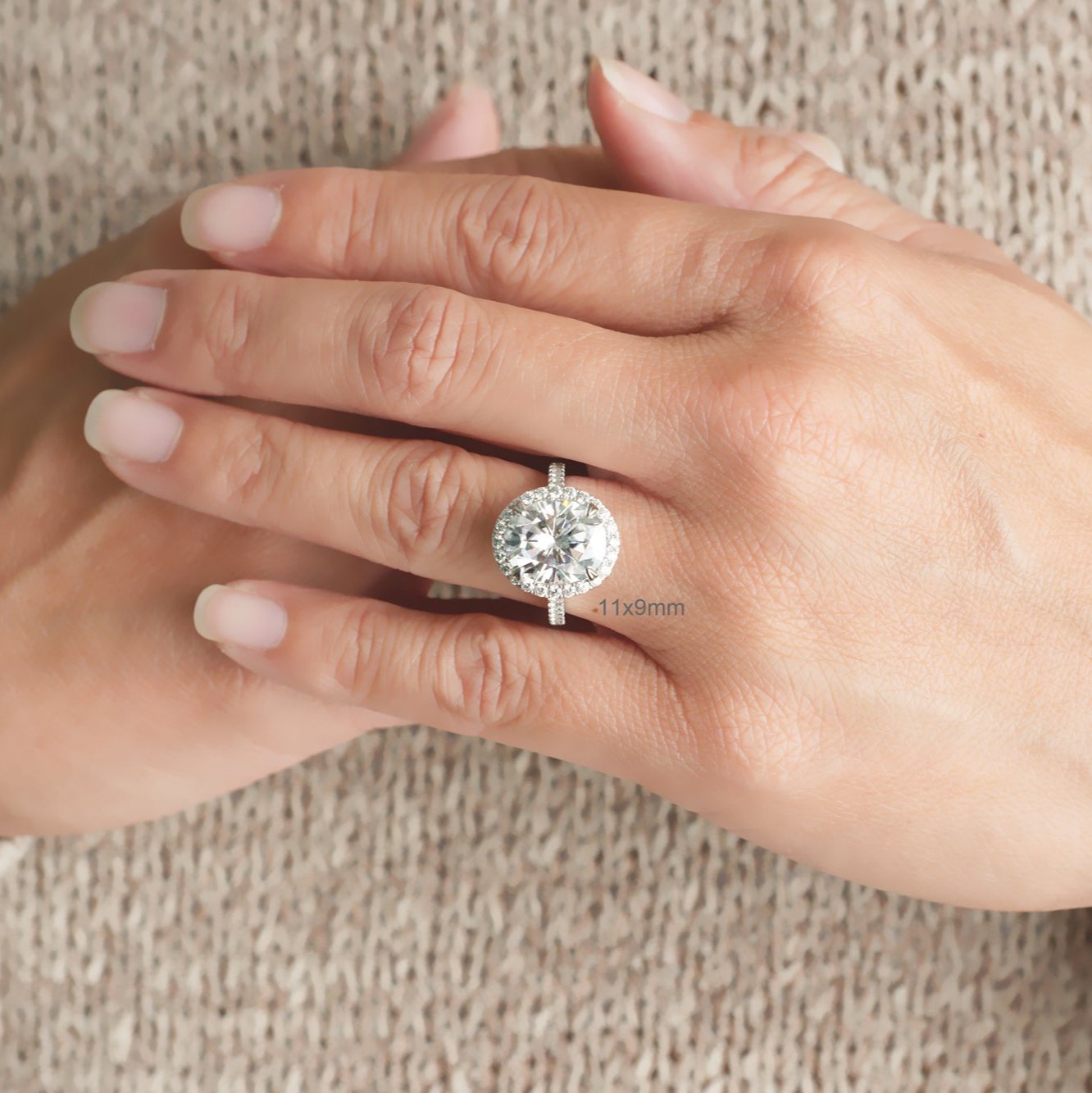 Oval cut moissanite engagement ring with a diamond halo in white gold