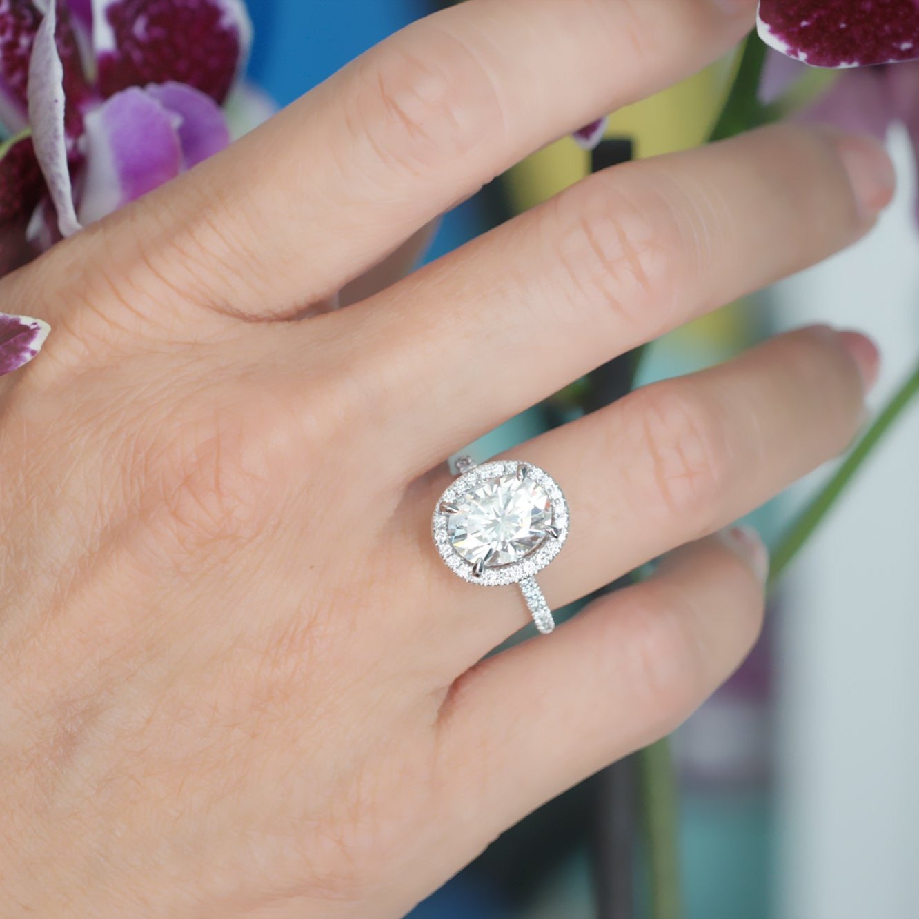 Oval moissanite cut engagement ring with diamond halo the Drenched white gold