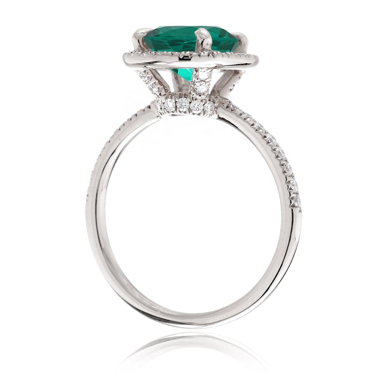 Oval cut emerald engagement ring with diamond halo the Drenched white gold side view