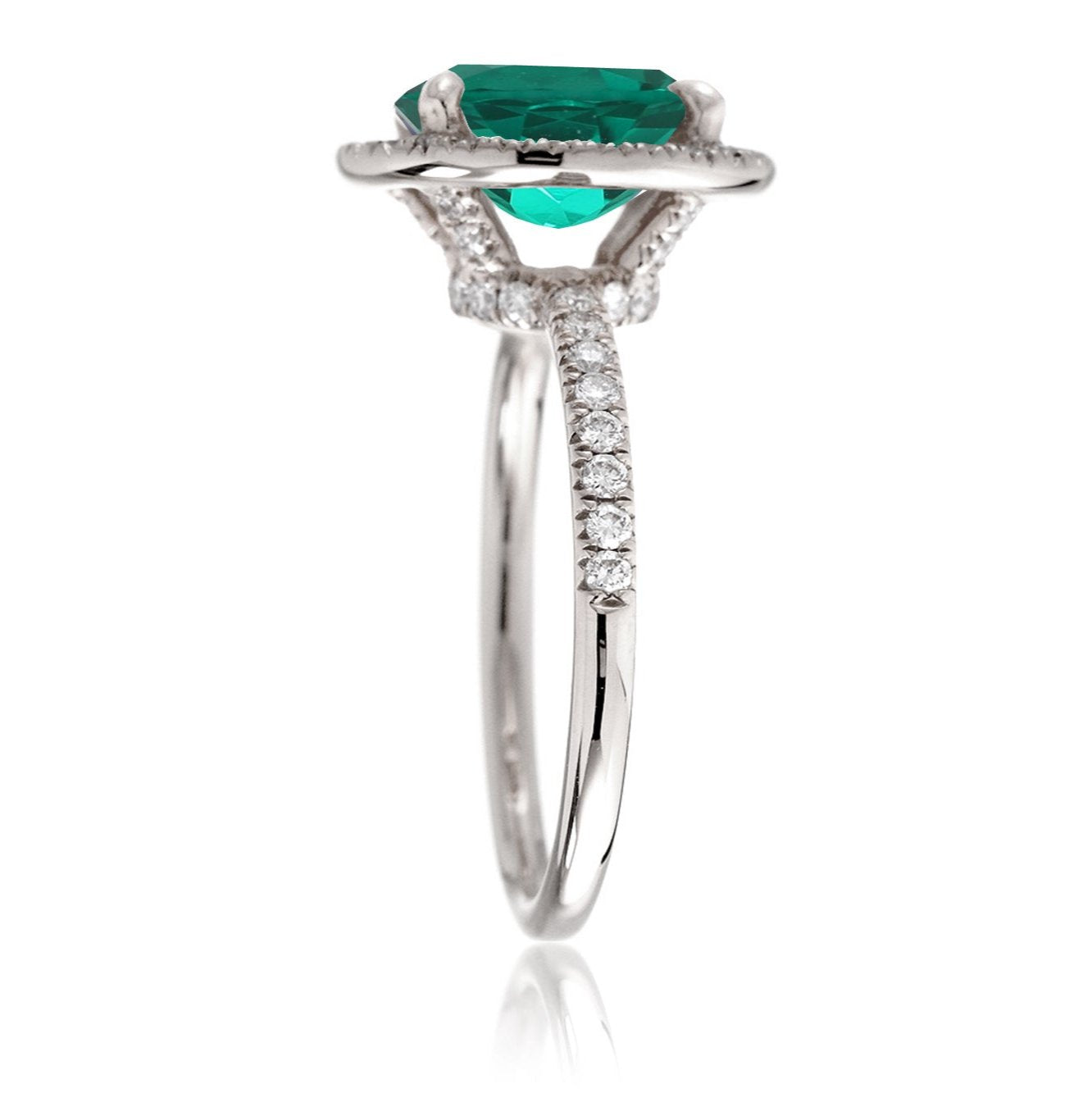 Oval cut emerald engagement ring with diamond halo the Drenched white gold profile view