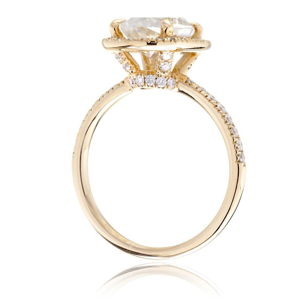 Oval moissanite cut engagement ring with diamond halo the Drenched yellow gold side view