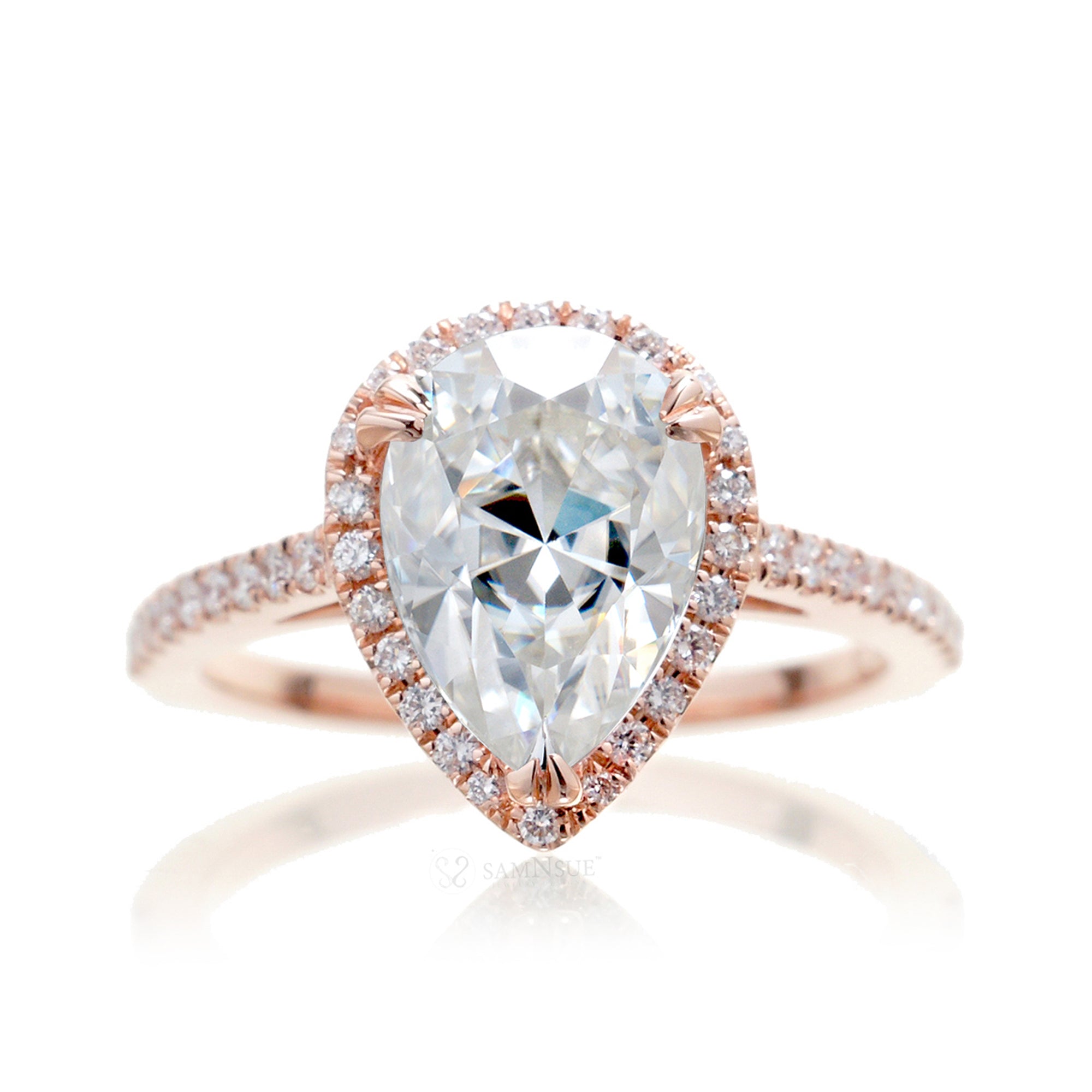 Pear moissanite and diamond halo ring in the signature rose gold