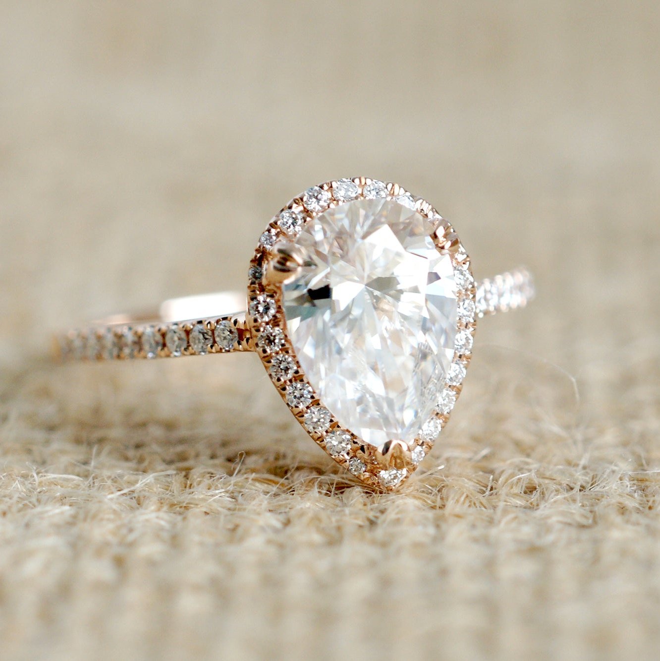 Pear moissanite ring with diamond halo in rose gold