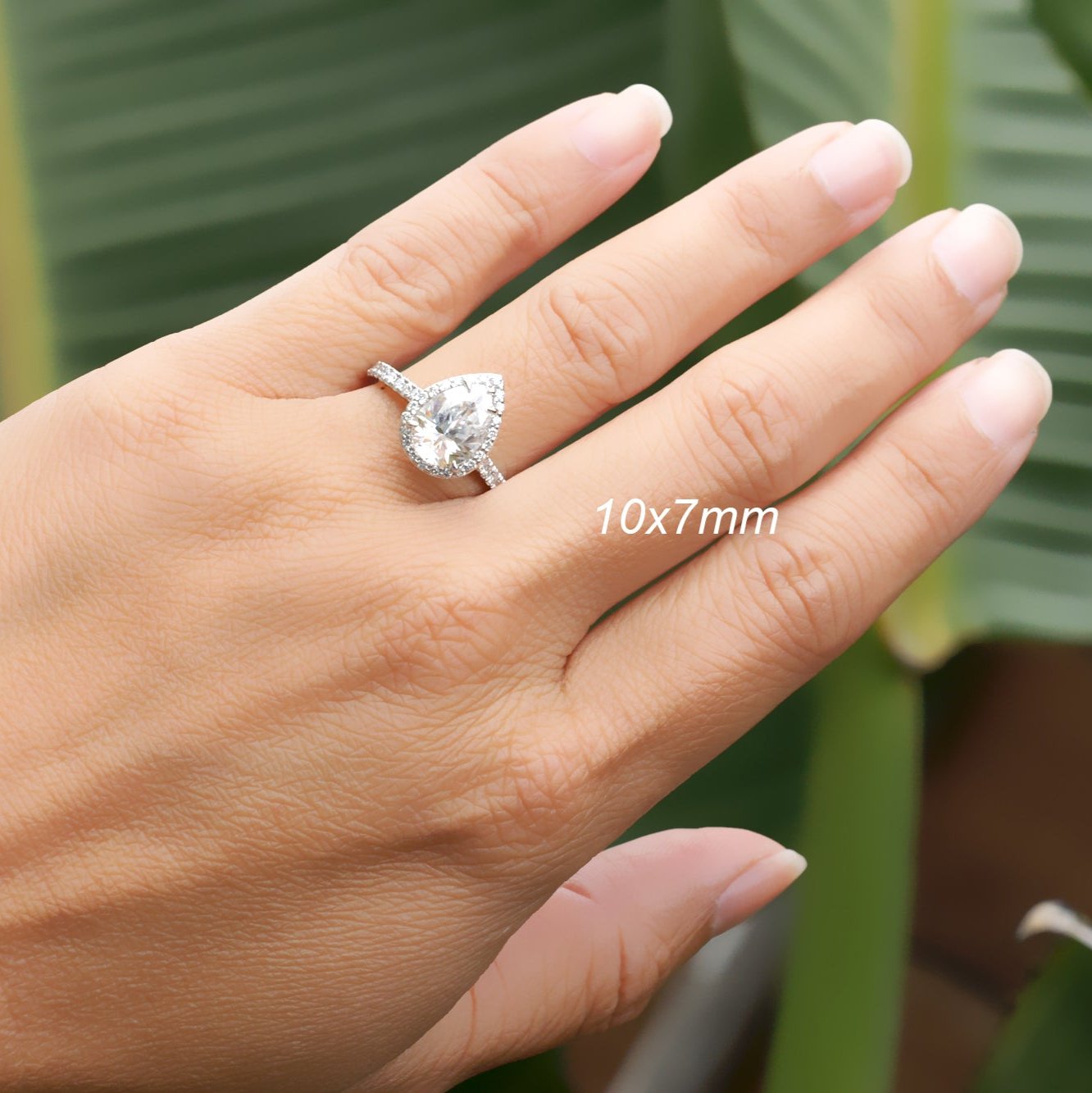 Pear moissanite ring with diamond halo in white gold