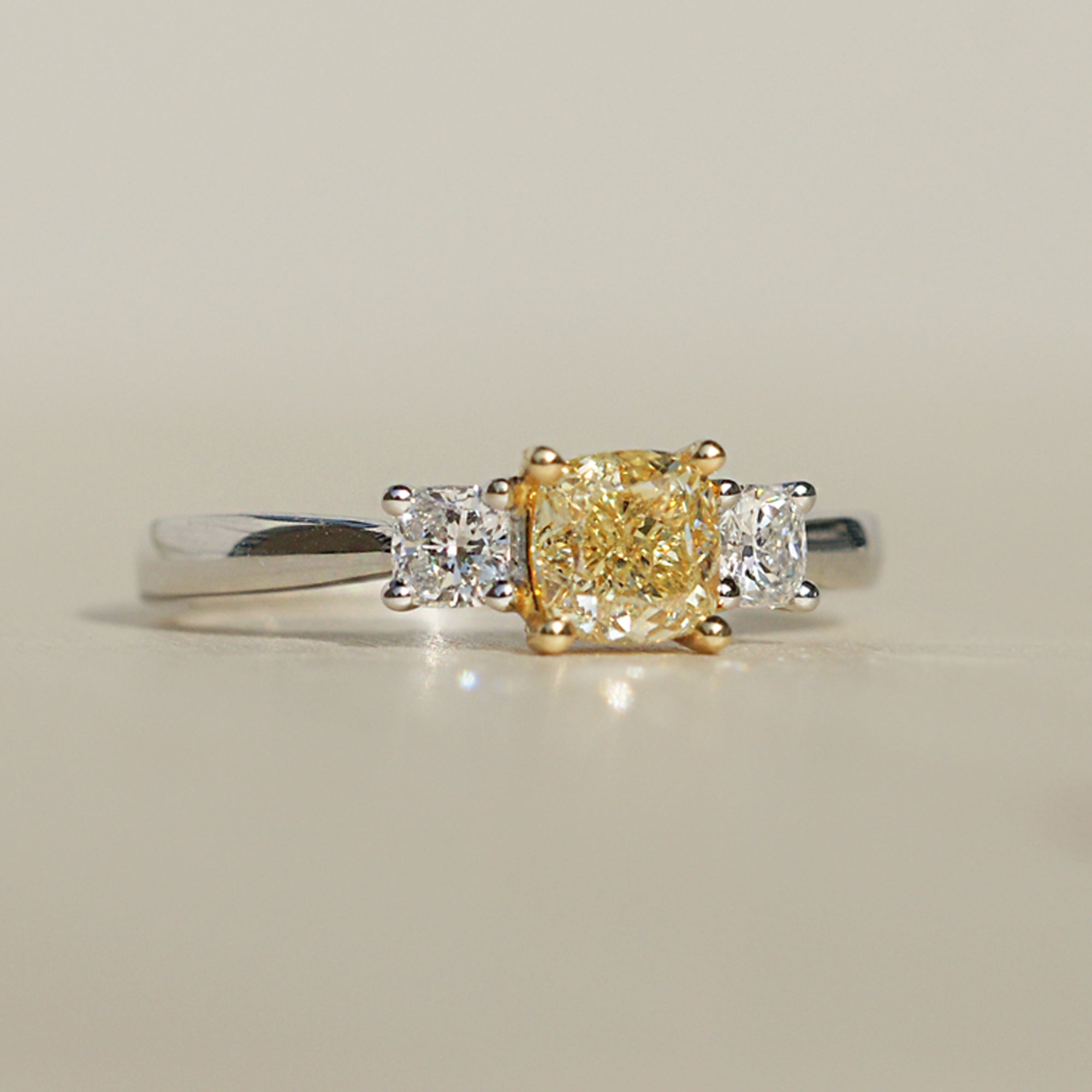 Fancy yellow color natural cushion diamond three stone engagement ring 