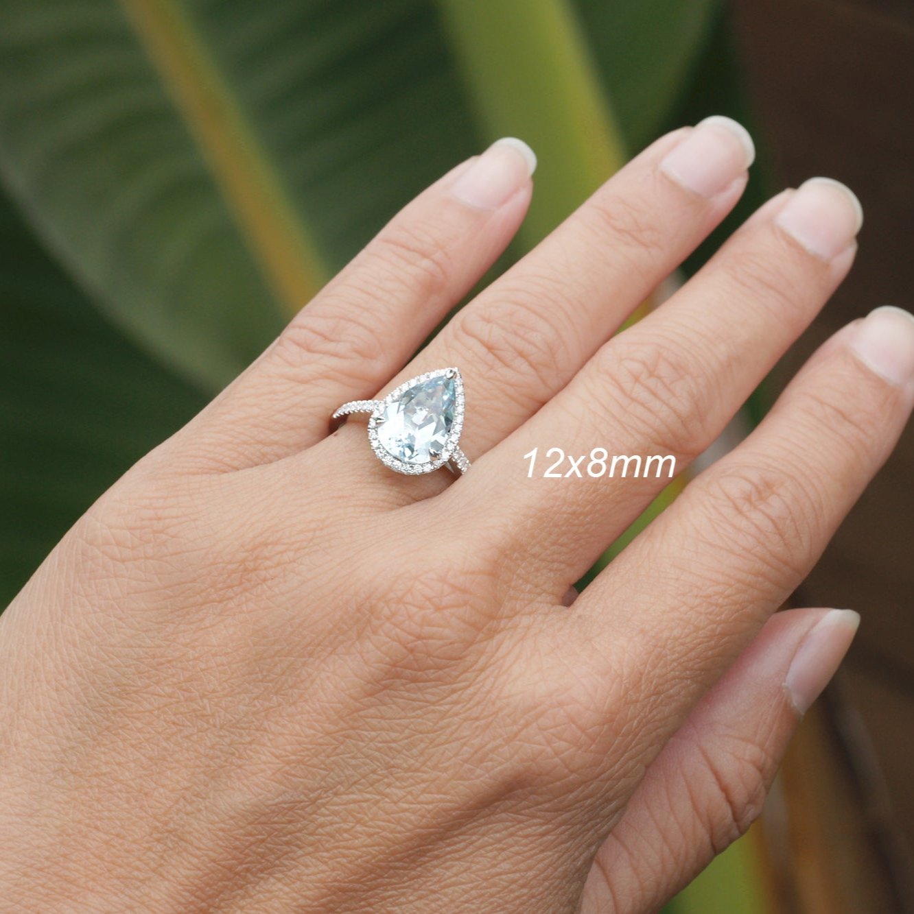 Pear aquamarine engagement ring with halo in white gold